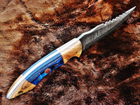 Close-up of exotic wood and olivewood handle on Damascus steel knife
