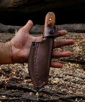 RidgeHunter Survival Knife in leather sheath, ideal for camping and hiking