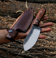 RidgeHunter high-carbon steel blade with rosewood handle in hand for outdoor use