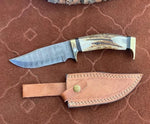 Handmade Damascus blade knife with brass guards and leather sheath
