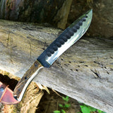 Camping knife being used for cutting wood