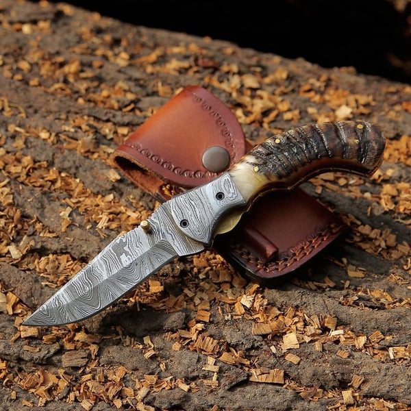 Mountain Majesty Damascus steel folding pocket knife with sheep horn handle and Damascus bolster