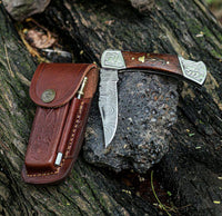 Damascus pocket knife with leather case and sharpening rod included.