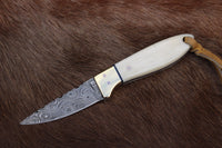 Buckaroo Bone Damascus Knife with 6.25-inch handmade Damascus steel blade and natural bone handle.
