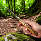 Close-up of Handmade Damascus Steel Tracker Knife with Olivewood Handle
