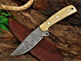 Damascus steel blade skinning knife with bone handle and leather sheath.
