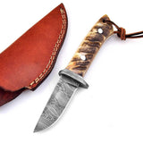 Damascus steel blade skinning knife with sheep horn handle and leather sheath.
