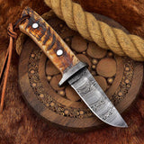 Great skinning knife with 7.75-inch Damascus blade, sheep horn handle, and Damascus guard.
