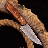 Custom handmade Damascus steel skinning knife with rosewood handle and fiber spacer.
