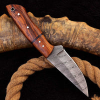 Great skinning knife for deer with rosewood handle, fiber spacer, and leather sheath.
