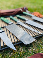 Close-up of the Damascus steel blades showcasing intricate patterns and full tang construction.