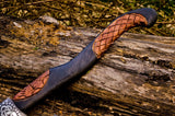 Hand engraved rosewood handle of the Battle Axe with detailed craftsmanship
