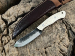 WildEdge high-carbon steel survival knife in hand showing bone grip