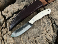 WildEdge high-carbon steel survival knife in hand showing bone grip