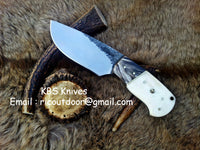 Custom 8-inch skinning knife with hand-forged 1095 steel blade and buffalo horn, camel bone handle.
