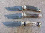 Damascus steel blade hunting knife featuring brass finger guard
