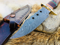 "Detailed view of Damascus steel blade with unique pattern on hunting knife."





