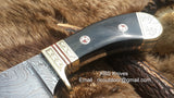 Close-up of the hand-engraved brass guard on the personalized deer skinning knife.